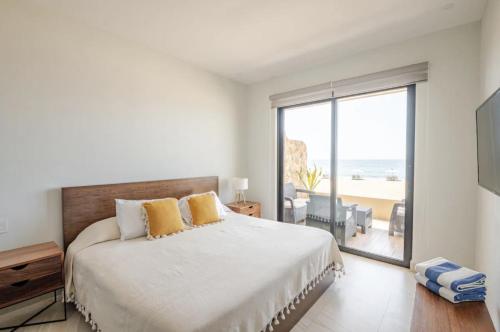a bedroom with a large bed with a view of the ocean at Oceanfront condo with terrace in San Francisco