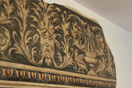 a wooden wall with a painting of animals on it at Hotel Antica Dimora, MantegnaHotels in Mantova