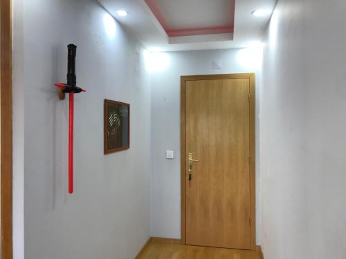 a room with a sword on the wall and a door at Hollywood Apartment in Bragança
