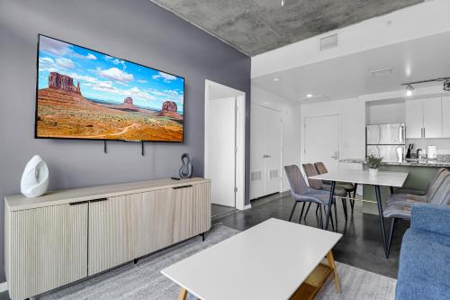 a living room with a tv on a wall at The Nomad Roosevelt in Phoenix
