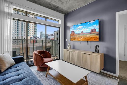 a living room with a couch and a tv at The Nomad Roosevelt in Phoenix