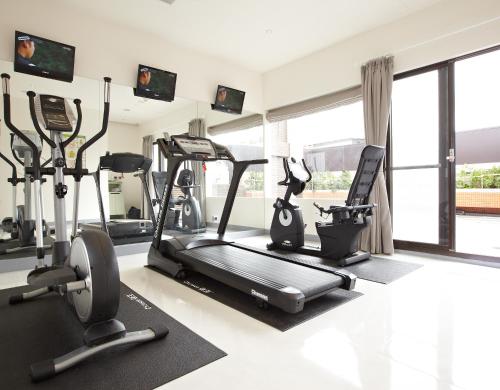 a gym with two treadmills and two exercise bikes at Beauty Hotels - Beautique Hotel in Taipei