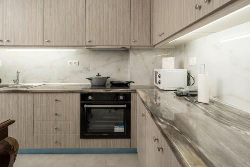 Η κουζίνα ή μικρή κουζίνα στο Manos Apartments