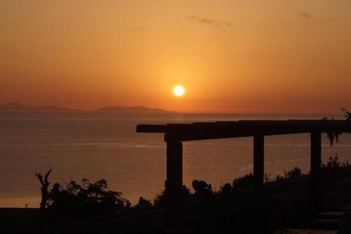 a sunset over the ocean with the sun in the sky at Terra Minoika Boutique Resort in Káto Zákros