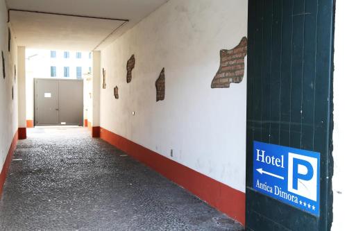 an empty hallway of a building with a parking garage at Hotel Antica Dimora, MantegnaHotels in Mantova
