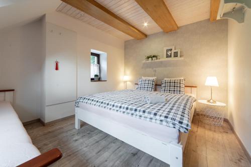 a bedroom with a large white bed in a room at Hamr Divci Kamen in Křemže