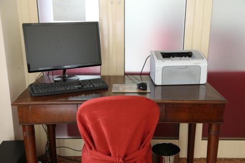 a desk with a computer monitor and a printer at Hotel Antica Dimora, MantegnaHotels in Mantova