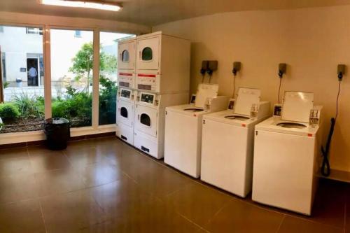 a room with four washer and dryers in a room at Fantástico estudio en CLC in Santiago