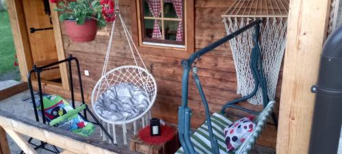 a porch of a play house with a swing at Koliba kod Vukašina in Kremna