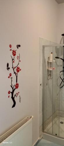 a bathroom with a shower and a tree on the wall at U Magdy apartament dla 4 osób 2 par parking w cenie samodzielne zameldowanie klucze w skrytce kod wysyłany przed przyjazdem in Borne Sulinowo