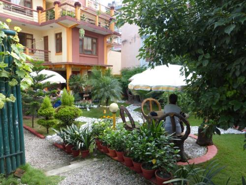 a garden in front of a building with plants at Elbrus Home in Kathmandu