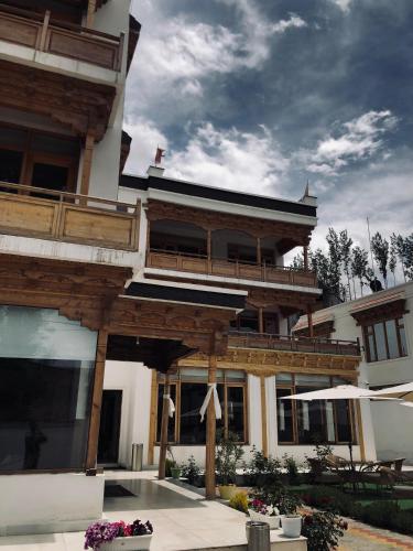 a large building with a balcony on top of it at Lha-Zes in Leh