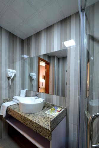 a bathroom with a sink and a mirror at Zolo Hotel in Ulaanbaatar