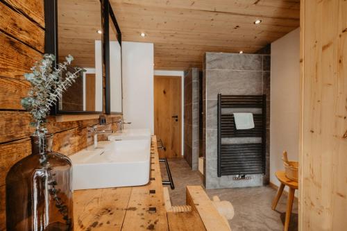 a bathroom with a white tub and a sink at Chalet BRUNNHÄUSL in Hüttschlag