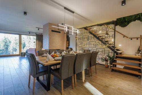 a dining room with a table and chairs at Valera Vita Forest House in Hlevci