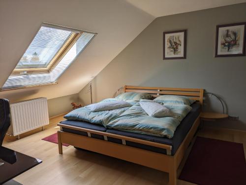 a bedroom with a bed with pillows on it at Radfahren, Reiten und mehr in Quierschied