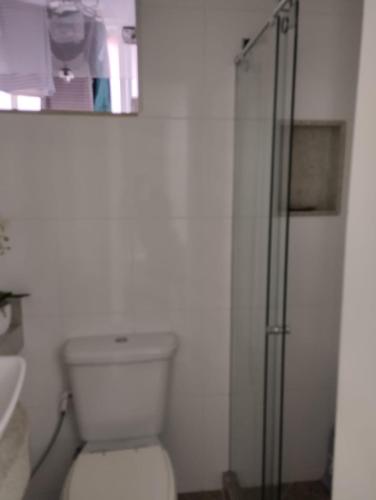 a bathroom with a toilet and a glass shower at Real Apartments 172 - 1 Quarto e 3 banheiros em Copacabana in Rio de Janeiro