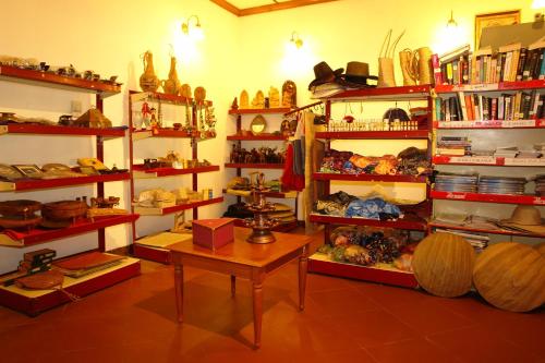 a room with shelves filled with lots of items at Backwater Ripples Kumarakom in Kumarakom