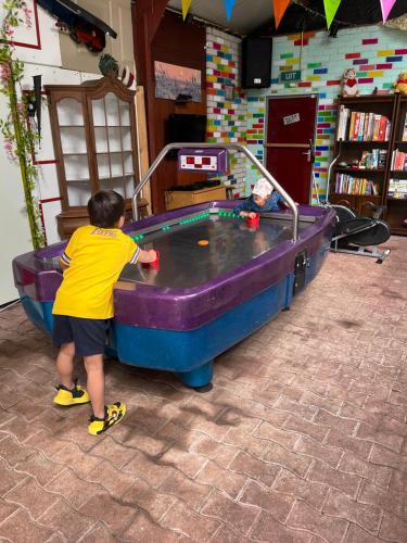 a young boy playing in a pool table at Mini Camping Drentse Monden in Nieuw-Weerdinge