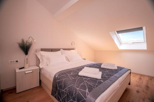 a bedroom with a bed with white sheets and a window at Hotel SOL in Bol