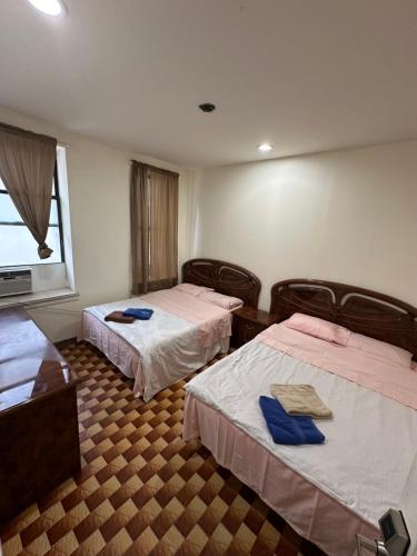 a hotel room with two beds and a window at Hudson Yard 408 in New York