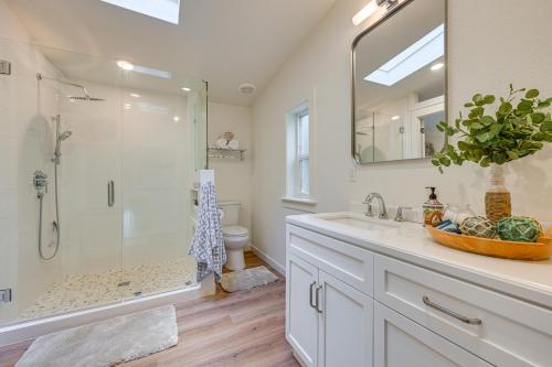 a white bathroom with a shower and a sink at Access to Lake Cushman Forested Hoodsport Home! in Hoodsport