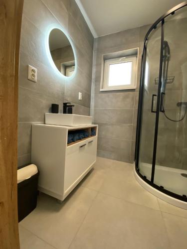 a bathroom with a sink and a shower at Šírava Resort in Klokočov