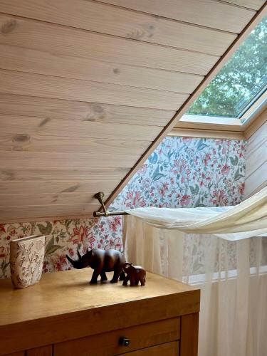 two bear statues sitting on top of a dresser at Pērles in Durbe