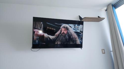 Μια τηλεόραση ή/και κέντρο ψυχαγωγίας στο Cómodo Apartamento frente al Mar