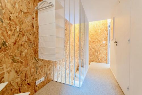 a hallway with a glass wall at Loft 4 personnes Métro L9 in Montreuil