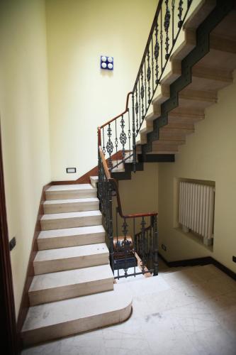 a staircase in an old building with wooden steps at Hotel Antica Dimora, MantegnaHotels in Mantova