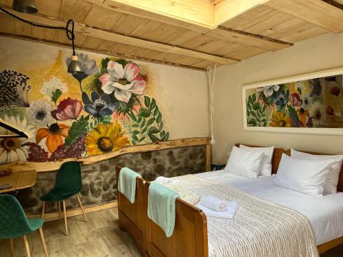a bedroom with two beds and a painting on the wall at Wąkop 6 Agroturystyka Eco in Nowa Słupia