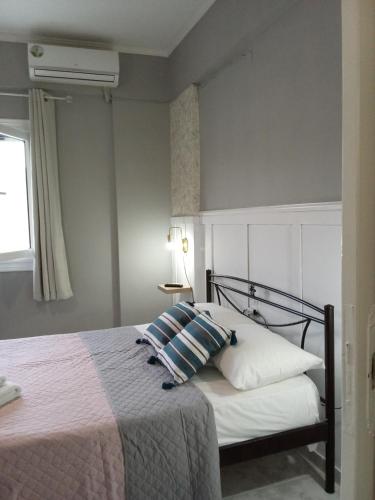 a bedroom with a bed with two pillows at Maistros Studios 1 in Argostoli