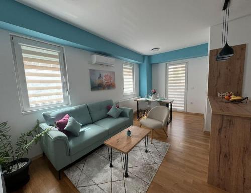 un soggiorno con un divano verde e un tavolo di TB apartment a Skopje