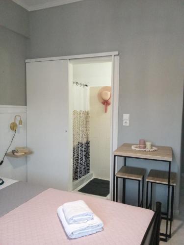 a room with a bed and a table and a mirror at Maistros Studios 1 in Argostoli
