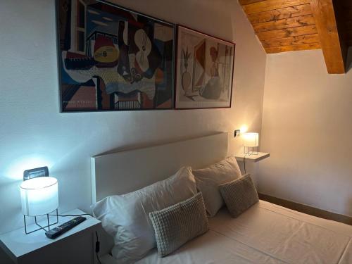 a bedroom with a white bed with pillows at B&B Villa Guido in Spezzano della Sila
