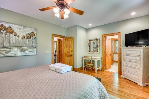 a bedroom with a bed and a flat screen tv at Luxe Trillium Home with Fire Pit, 5 Mi to Cashiers in Cullowhee