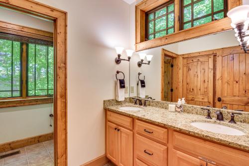 a bathroom with two sinks and a mirror at Luxe Trillium Home with Fire Pit, 5 Mi to Cashiers in Cullowhee