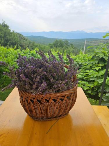 a basket filled with purple flowers sitting on a table at Green Silence - Vuk in Podgorica
