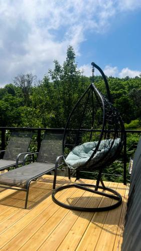 a chair sitting on top of a deck at Utopia Inn უტოპია ინნ in Batumi