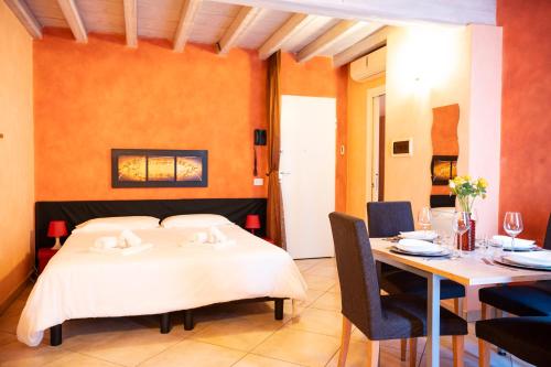 a bedroom with a bed and a table and chairs at Al Podestà - Centro Storico in Mantova