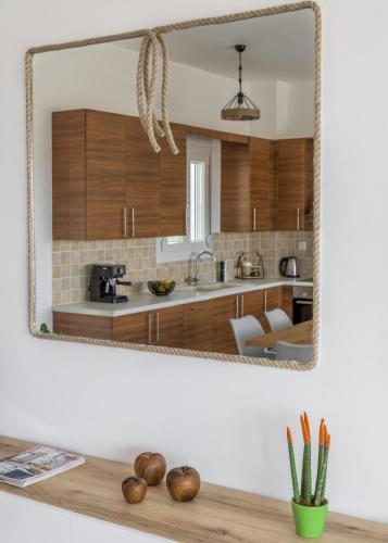 a mirror on a wall above a counter in a kitchen at Alkyonis Visus House in Triovasálos