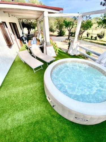 a hot tub on the lawn of a house at Villa Bianca in Tertenìa