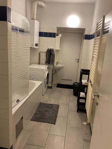 a bathroom with a tub and a toilet and a sink at Palace Apartment in Vienna