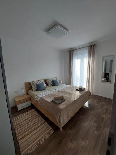 a bedroom with a large bed and a window at Apartments Mišković in Vir