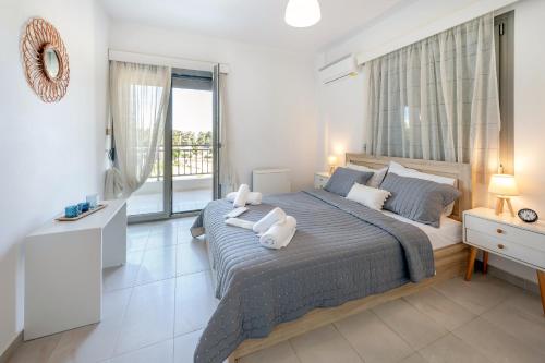 a bedroom with a bed with two pillows on it at City Calm House in Platánion