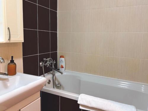 a bathroom with a white tub and a sink at Charming,lovely and central with park view in Chişinău