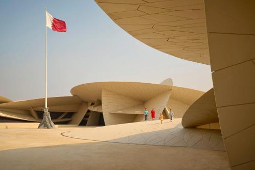 a view of the exterior of a building with a flag at Best Plaza West Bay Hotel in Doha