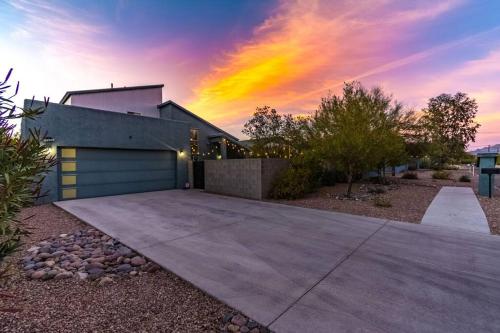 a house with a driveway in front of a sunset at Mid Century Modern Game Room in Tucson