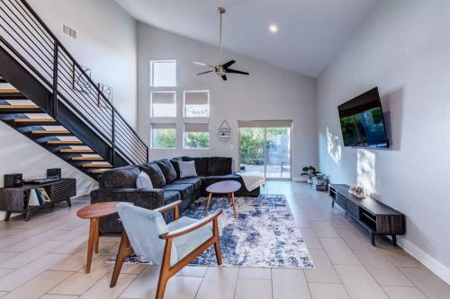 a living room with a couch and a table at Mid Century Modern Game Room in Tucson
